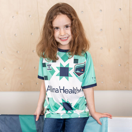 Teal and white soccer jersey with geometric star patterns