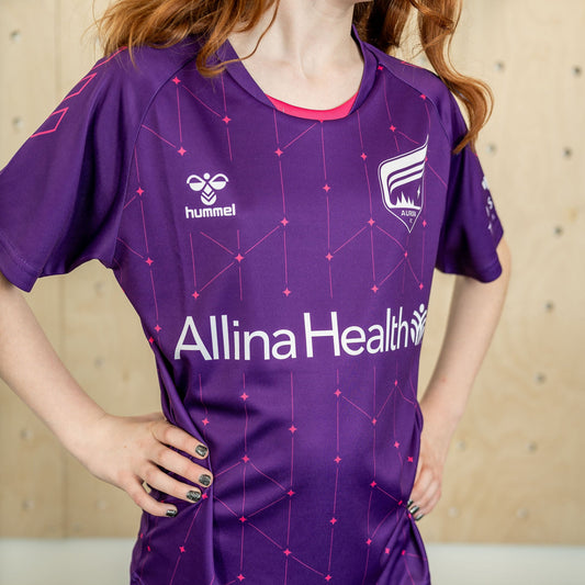 Purple soccer jersey decorated with pink stars and lines
