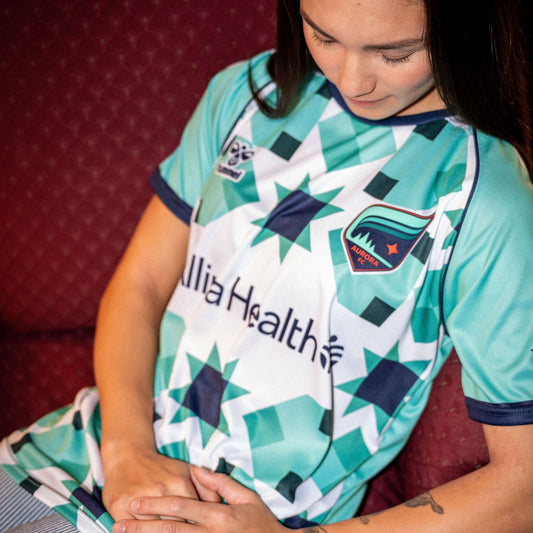 Teal and white soccer jersey with geometric star patterns