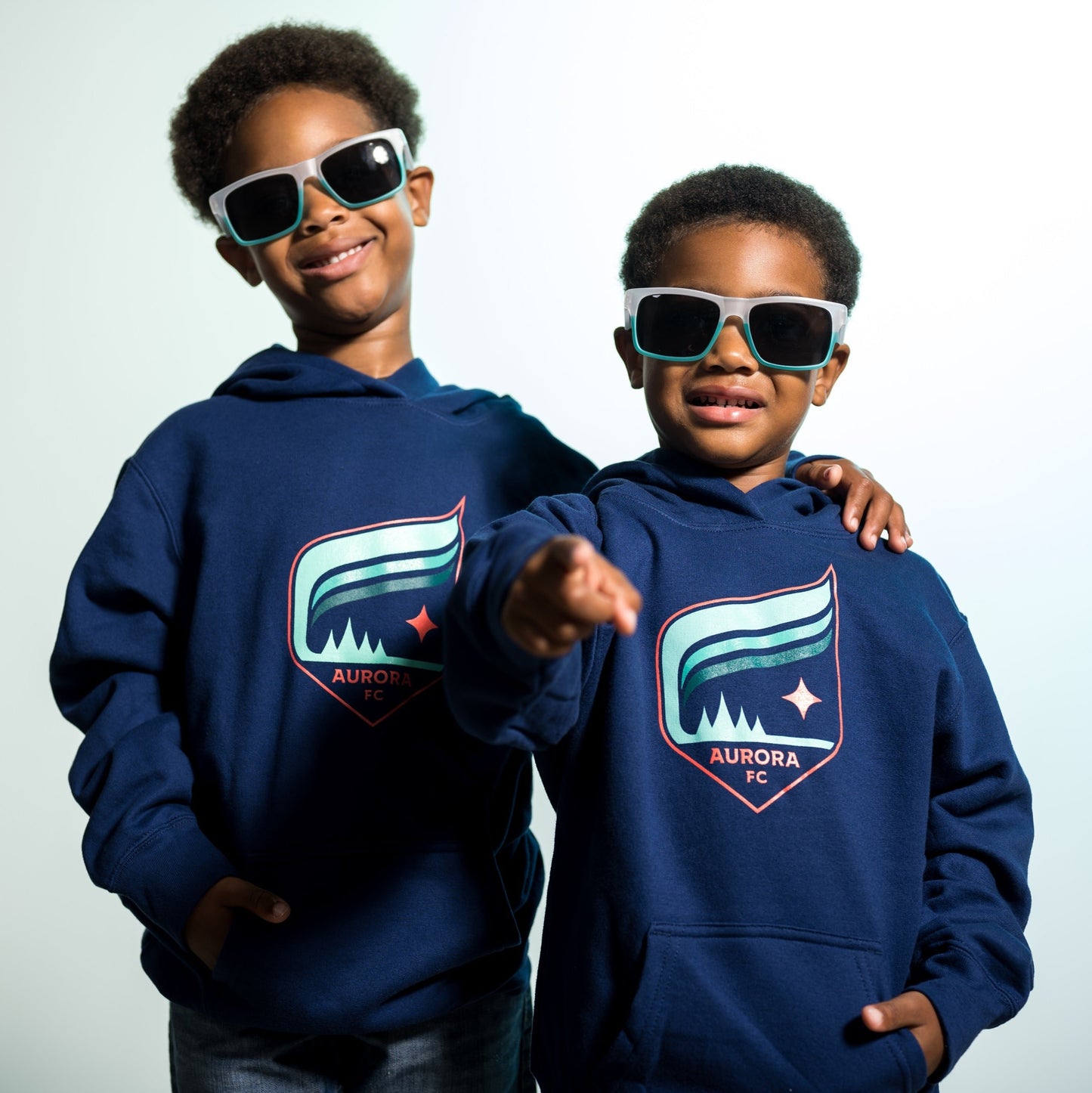 Navy blue hoodie with the Aurora crest that features the colors teal and orange
