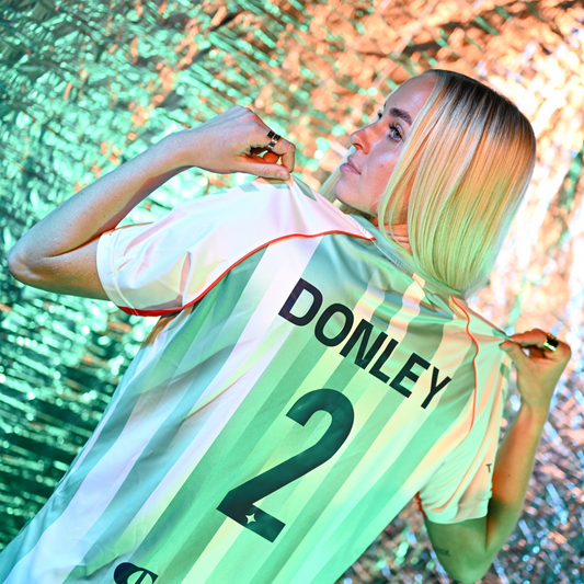 Teal and white striped soccer jersey with orange accents