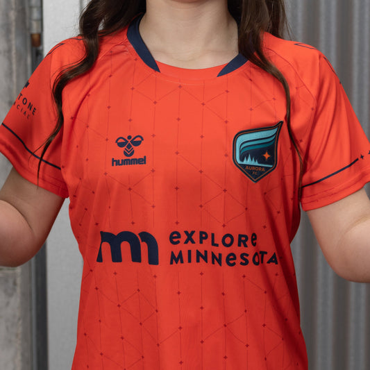 Bright red soccer jersey with dark red stars and lines with black accents