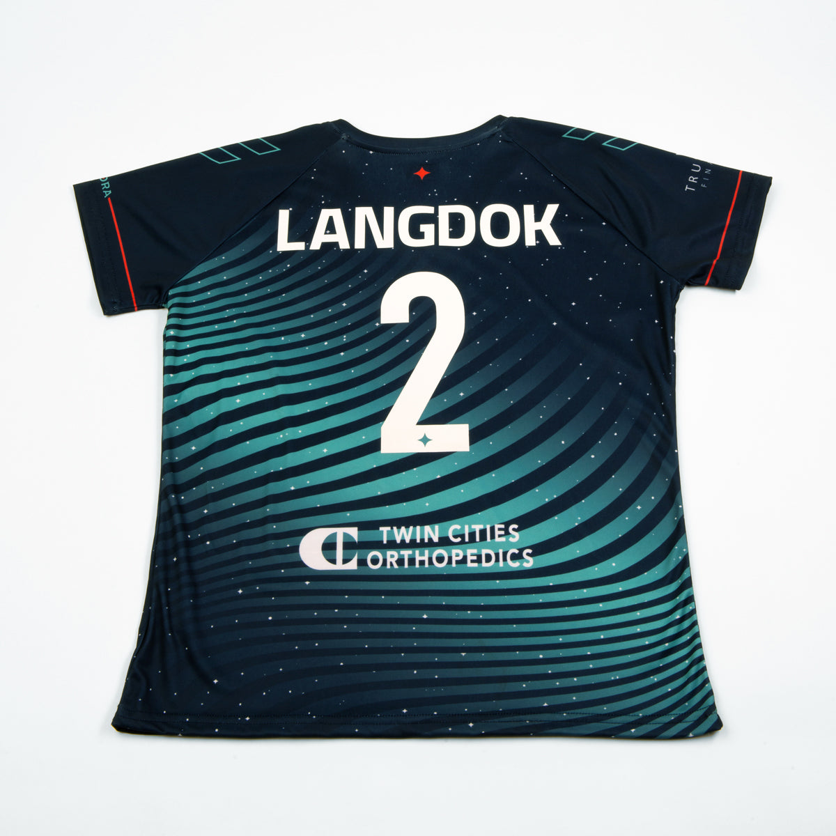 Navy soccer jersey with teal wavy pattern and orange accents