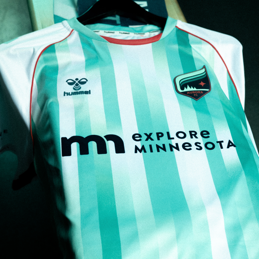 Teal and white striped soccer jersey with orange accents