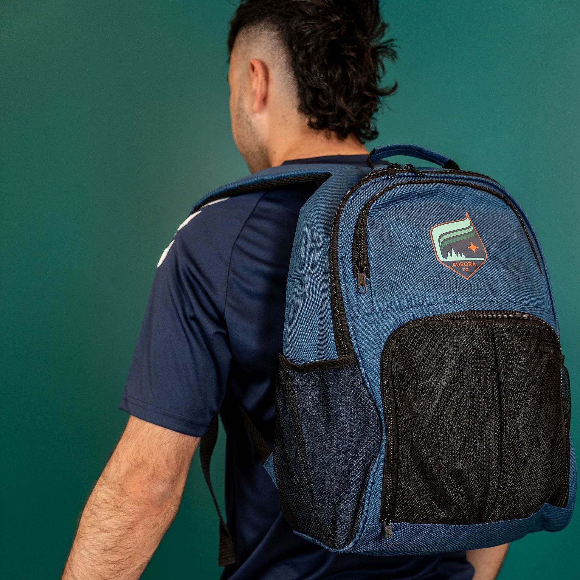 Blue backpack with black accents featuring the Aurora crest