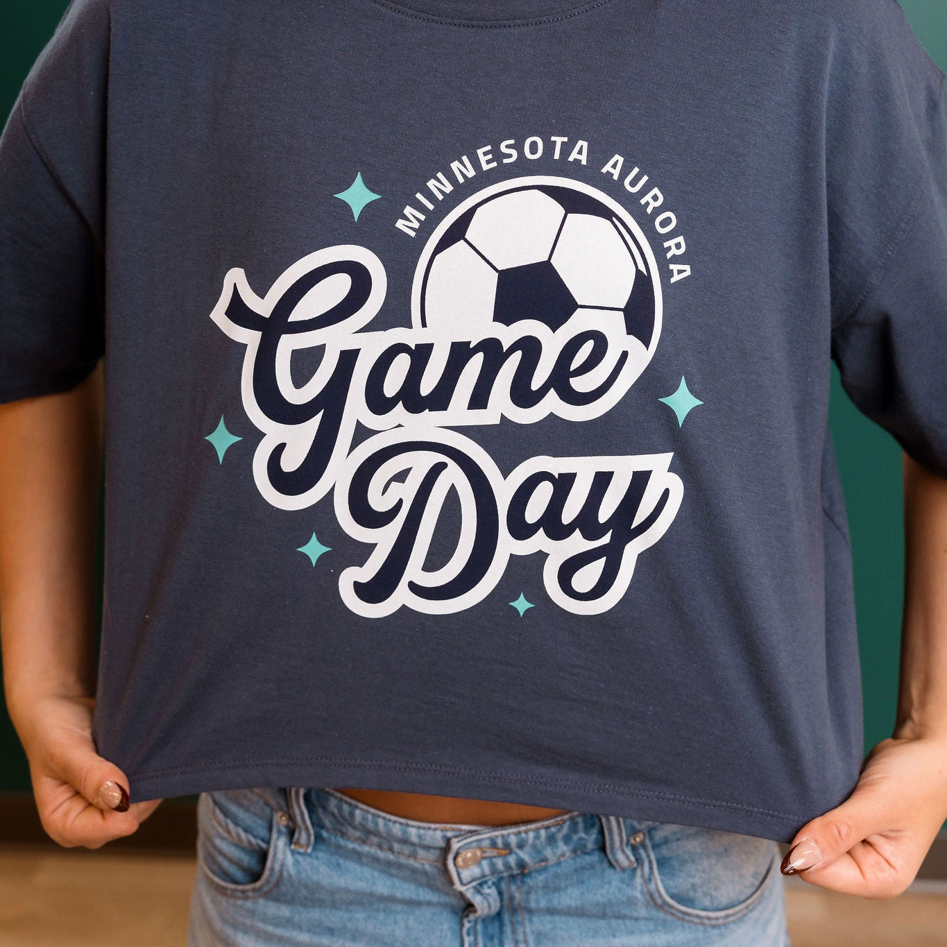 Navy blue t-shirt with 'Minnesota Aurora Game Day' design worn by a person.