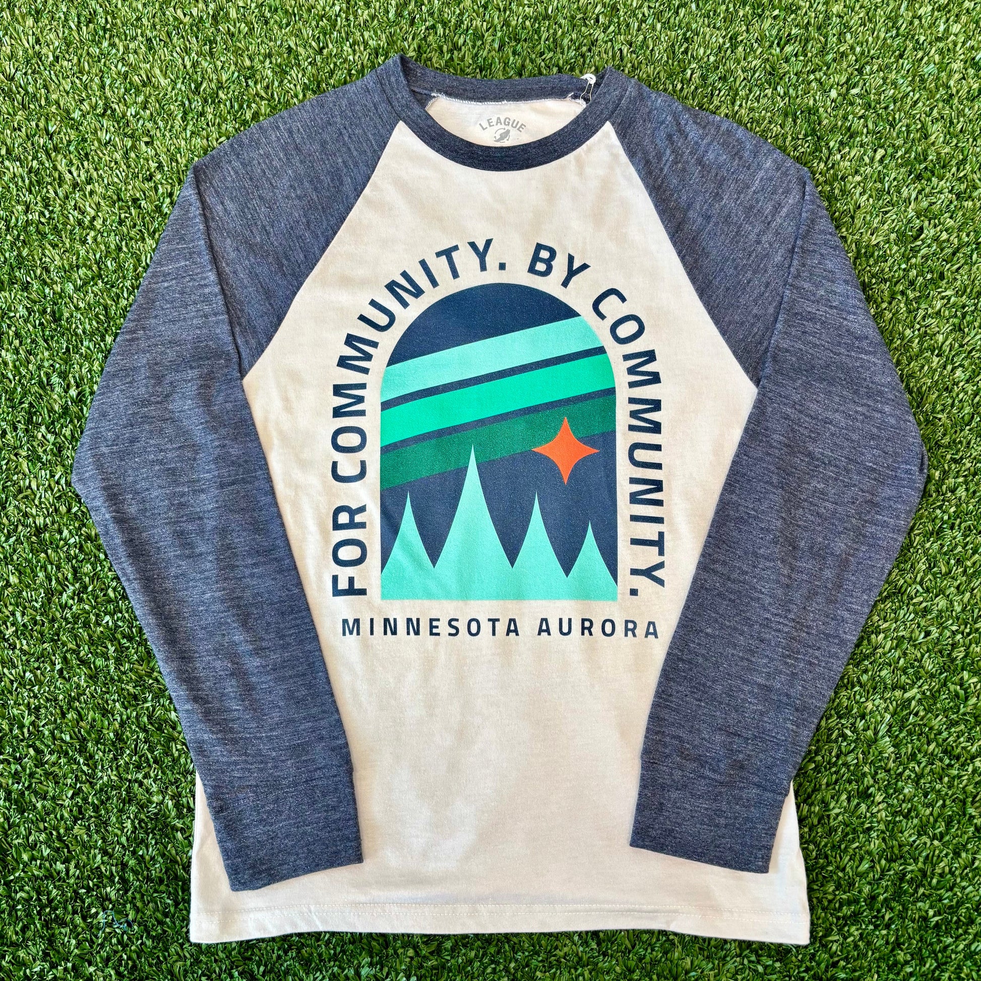 Long-sleeve shirt with graphic design on a grass background