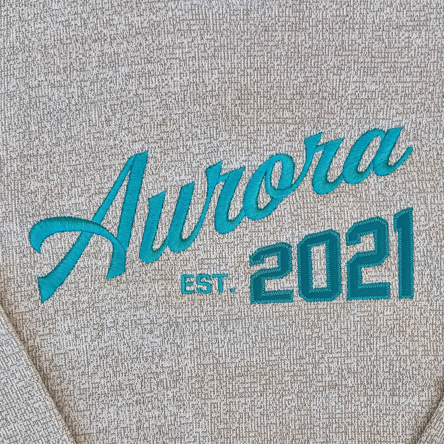Ivory sweatshirt with 'Aurora Est. 2021' text 