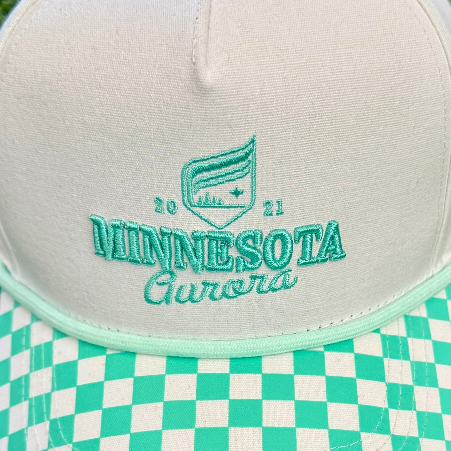 Cap with 'Minnesota' branding on a green grass background