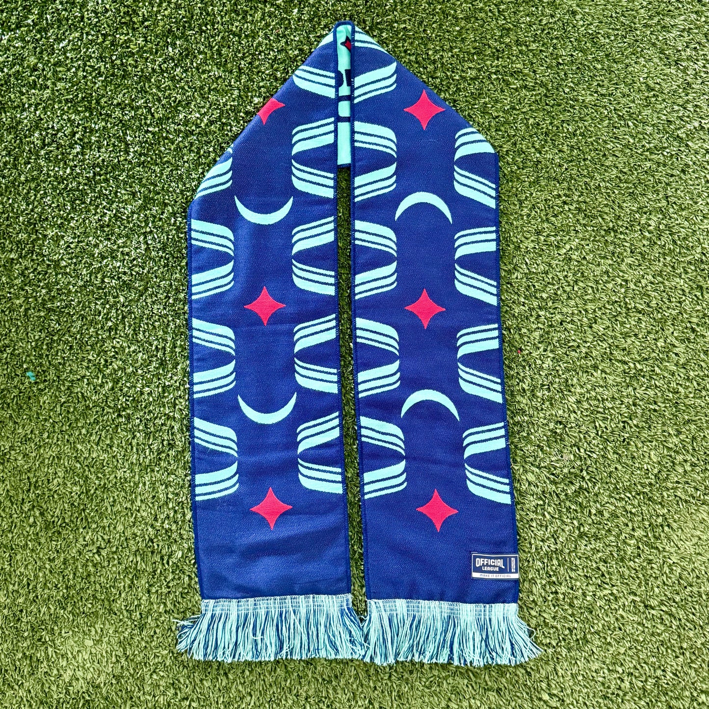 Blue patterned scarf on a green grass background